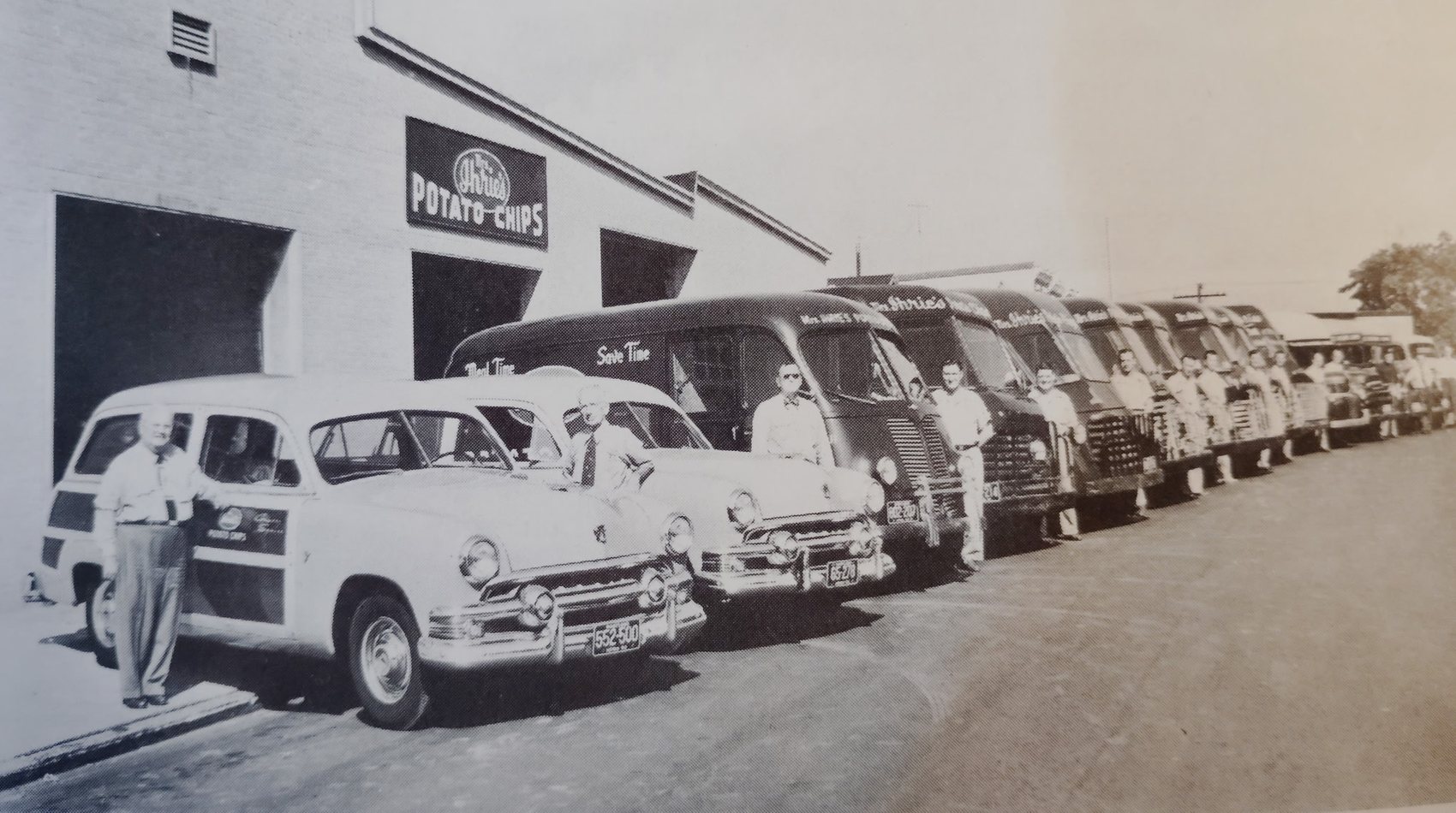 The Mrs. Ihrie's Potato Chips plant in Baltimore, with the delivery fleet and its drivers lined up outside